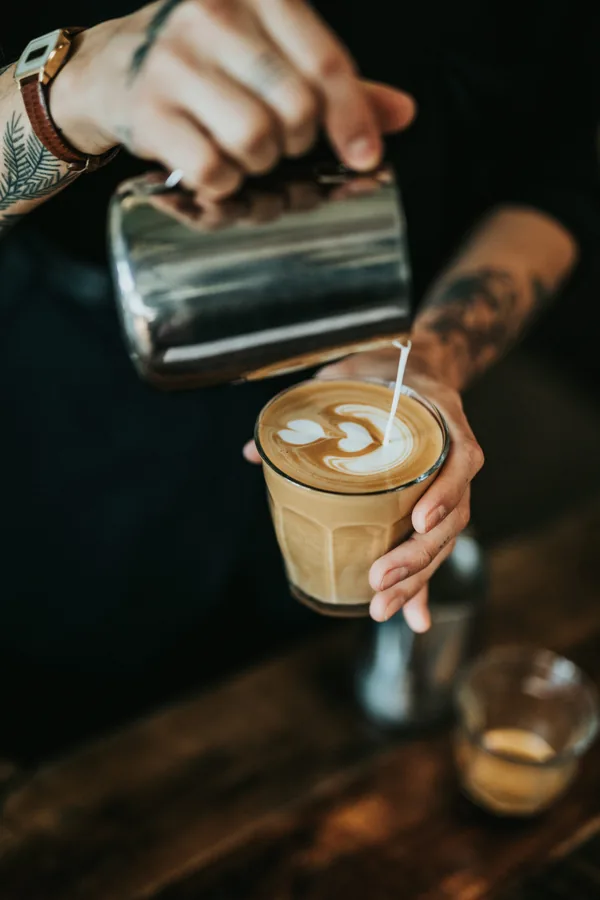 A barista preparing a latte